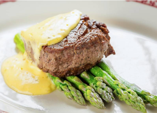Filet bearnaise, a 4-ounce filet mignon with steamed asparagus and bearnaise sauce, is now available on Gene & Georgetti's new prime time menu in its lounge area.